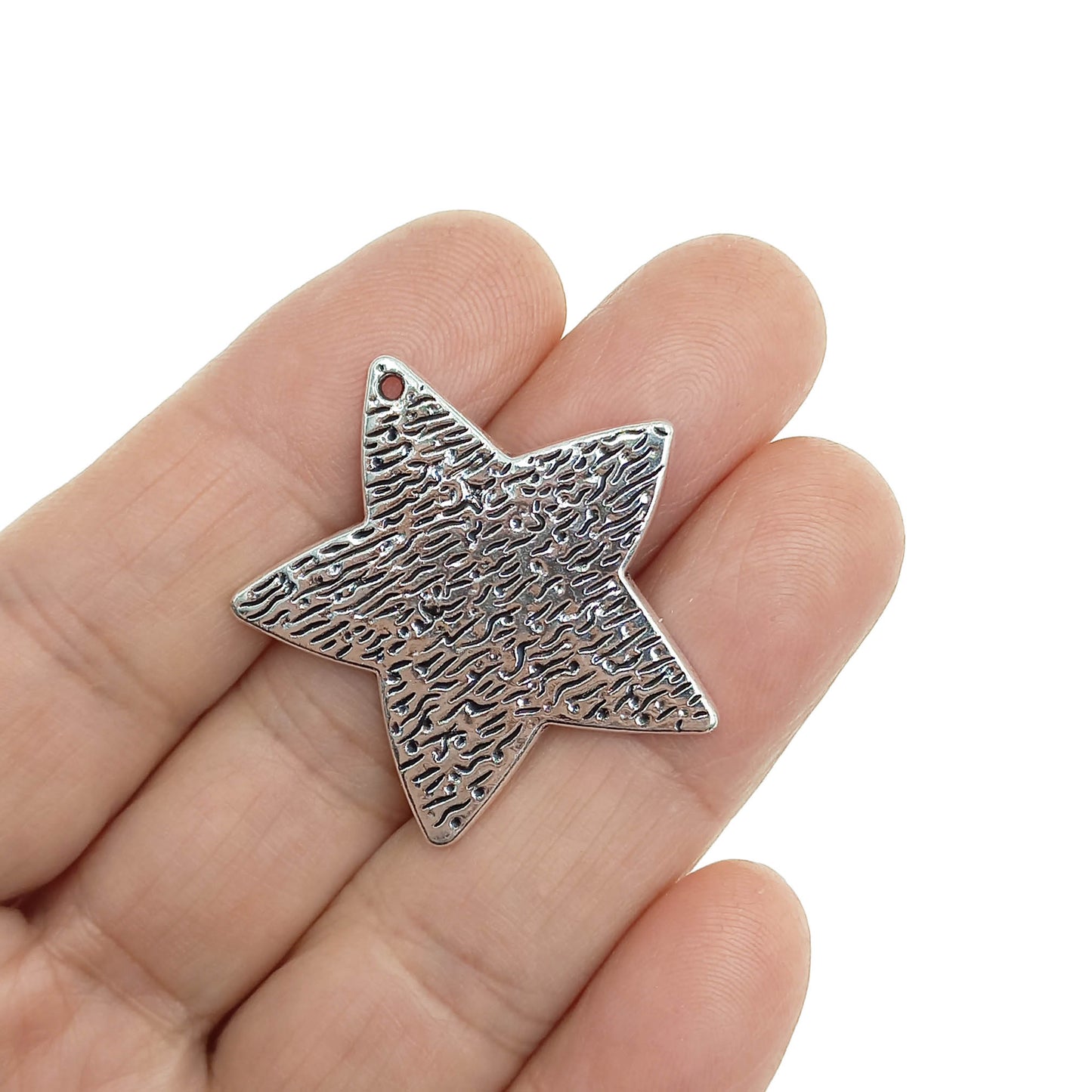 dije estrella mano